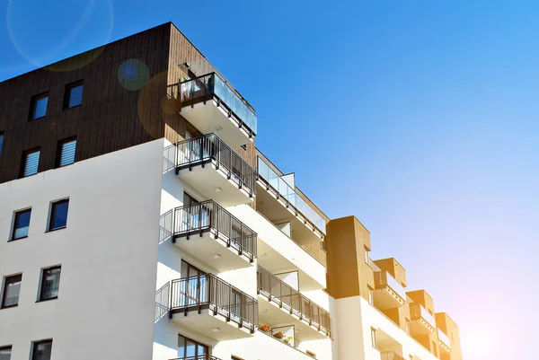 Güneş ışınları kentsel binalar üzerinde ışık etkisi yaratıyor. Düz binaları olan modern bir apartman dairesi. Yeni lüks ev ve ev kompleksinin ayrıntıları. 