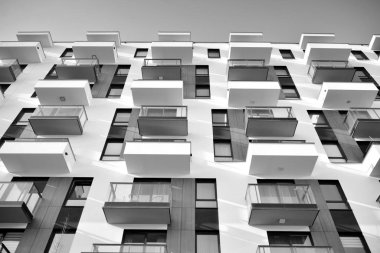 Modern and new apartment building. Multistoried, modern, new and stylish living block of flats. Black and white.