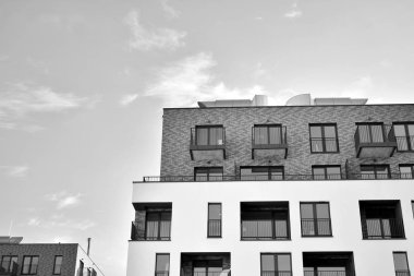 Modern and new apartment building. Multistoried, modern, new and stylish living block of flats. Black and white.