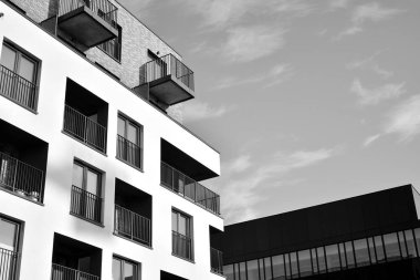 Modern and new apartment building. Multistoried, modern, new and stylish living block of flats. Black and white.