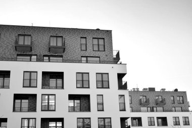 Modern and new apartment building. Multistoried, modern, new and stylish living block of flats. Black and white.