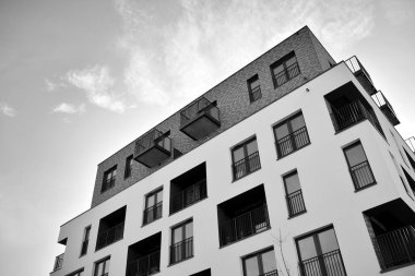 Modern and new apartment building. Multistoried, modern, new and stylish living block of flats. Black and white.