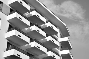 Modern and new apartment building. Multistoried, modern, new and stylish living block of flats. Black and white.