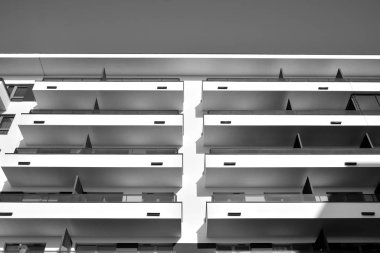 Modern and new apartment building. Multistoried, modern, new and stylish living block of flats. Black and white.