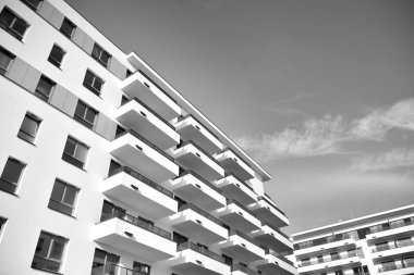 Modern and new apartment building. Multistoried, modern, new and stylish living block of flats. Black and white.