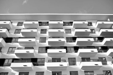 Modern and new apartment building. Multistoried, modern, new and stylish living block of flats. Black and white.