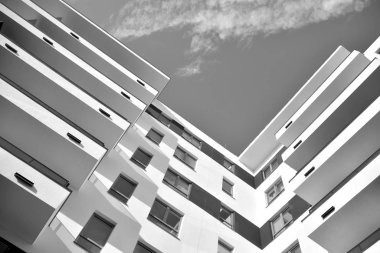 Modern and new apartment building. Multistoried, modern, new and stylish living block of flats. Black and white.