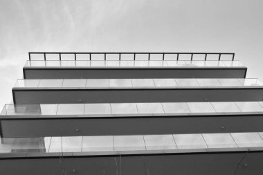 Modern and new apartment building. Multistoried, modern, new and stylish living block of flats. Black and white.