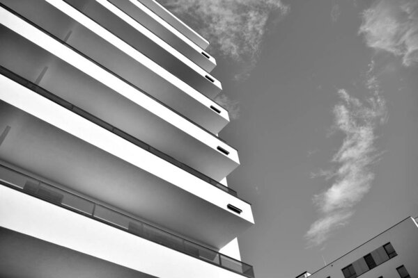 Modern and new apartment building. Multistoried, modern, new and stylish living block of flats. Black and white.