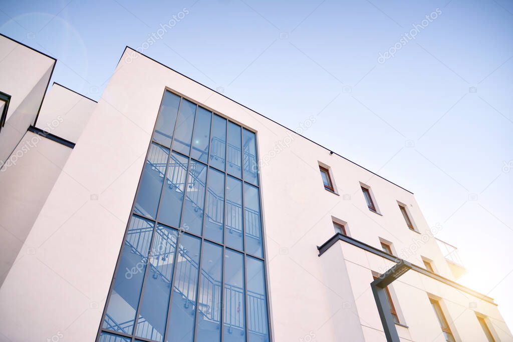 Sun rays light effects on urban buildings. Fragment of modern residential apartment with flat buildings exterior. Detail of new luxury house and home complex. 