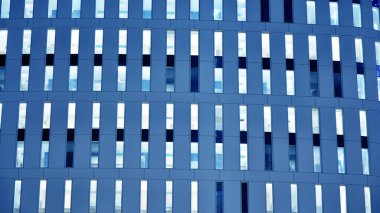 Gece mimarisi - cam cepheli bina. Gece ışıklarının mavi rengi. İş bölgesinde modern bir bina. Ekonomi kavramı, mali. 