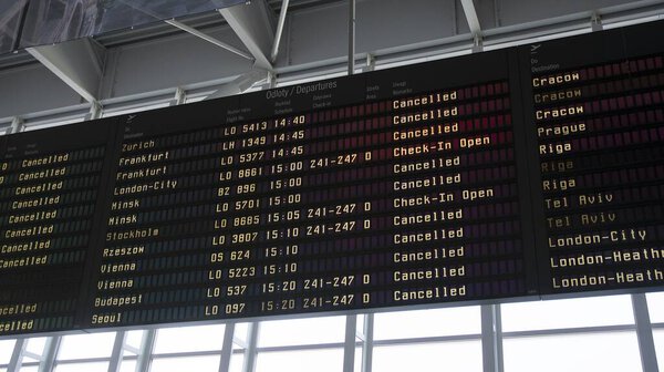 Warsaw, Poland. 18 March 2020. Airport billboard panel with cancelled flights during coronavirus covid-19 epidemic crisis in Warsaw airport. 
