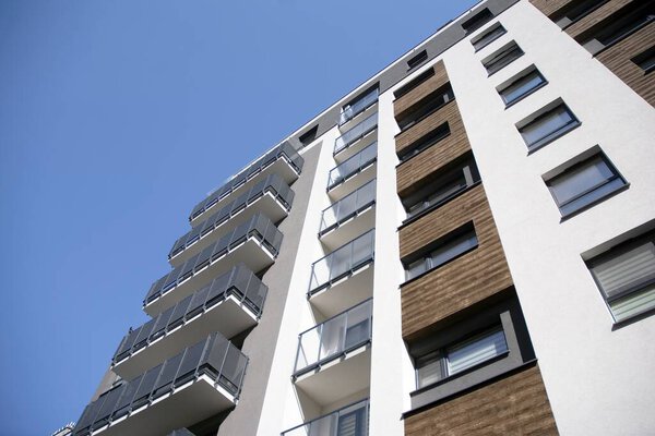Urban lifestyle. Facade of new modern residential house. Apartment building in the city. 