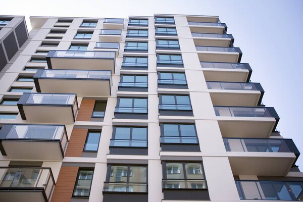 Beautiful designed multistory house with glass facade balconies in city district architecture, luxury real estate property apartments for sale
.