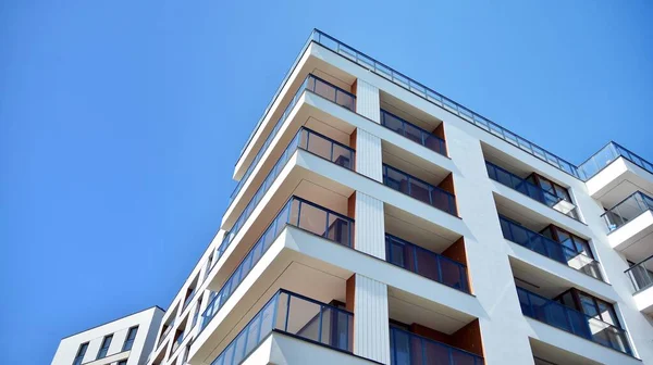 Residential Building on sky background. Facade of a modern housing construction with of balconies.