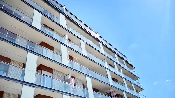 Residential Building on sky background. Facade of a modern housing construction with of balconies.