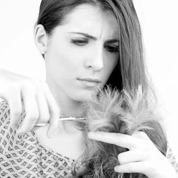 Woman cutting split ends hair — Stock Photo, Image