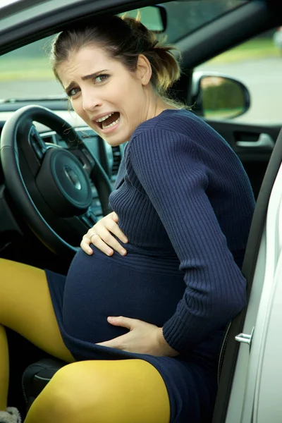 Mujer embarazada en coche sintiendo dolor asustado gritando —  Fotos de Stock