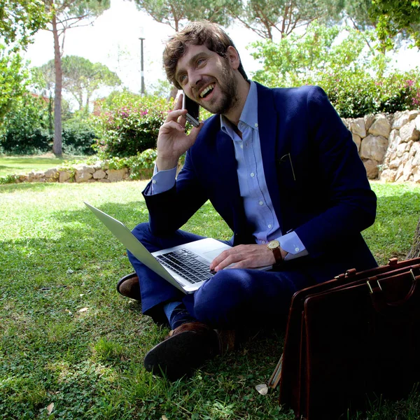 公園広い翔を笑いで電話で幸せなビジネスの男性 — ストック写真