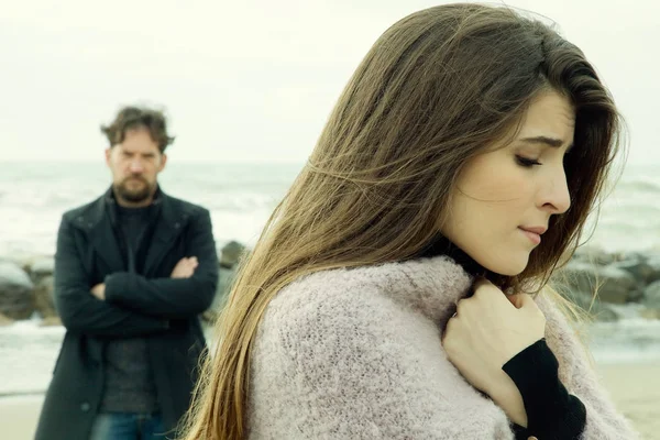 Angry man looking sad girlfriend after fight in front of the ocean | Stock Images Page | Everypixel