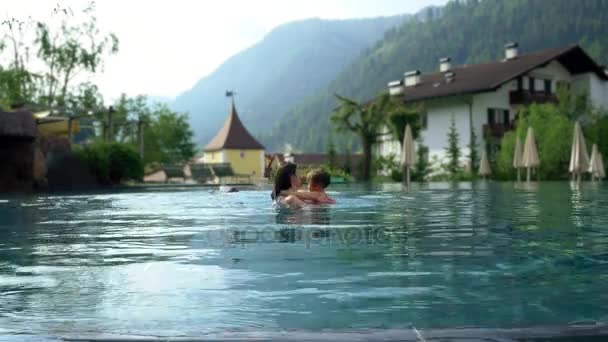 愉快的家庭在温泉的假期室外游泳池在山宽射击 — 图库视频影像