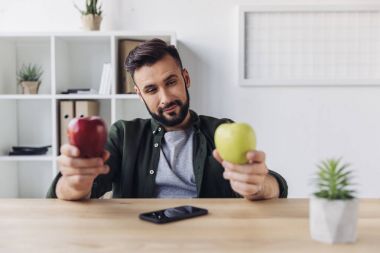 Businessman holding apples 