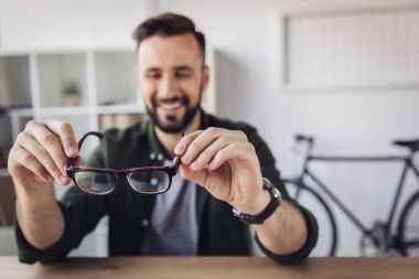 Man holding eyeglasses  clipart