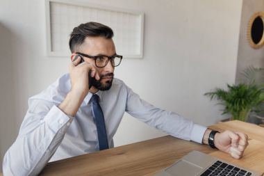 smartphone üzerinde konuşan işadamı