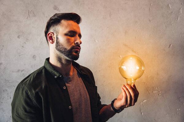 Man holding light bulb 