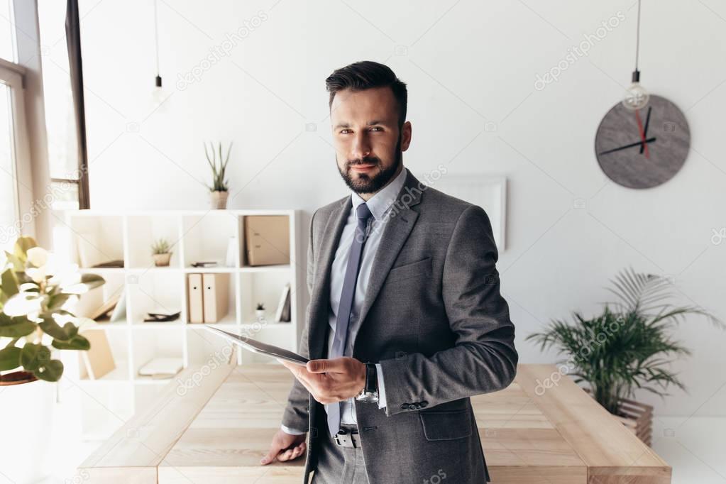 businessman holding tablet