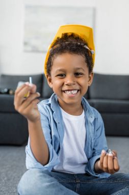 happy afro boy in protective hardhat clipart