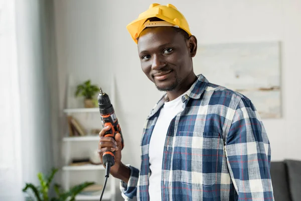 African-american man with perforator — Stock Photo, Image