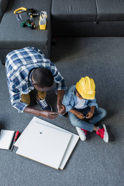 african-american father and son doing renovation