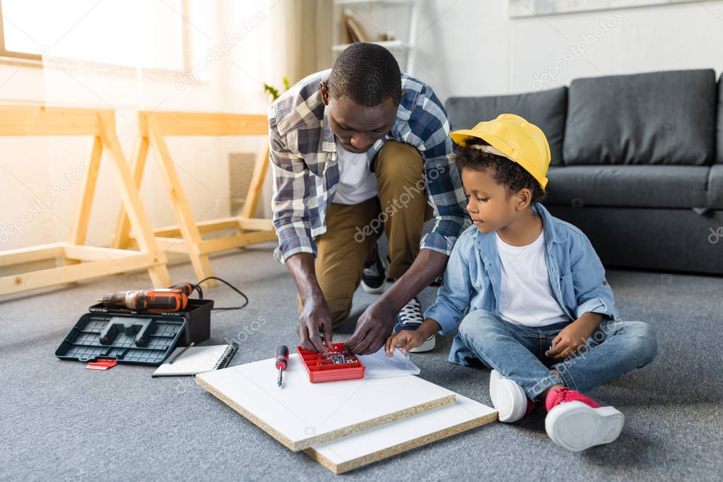 african-american father and son doing renovation