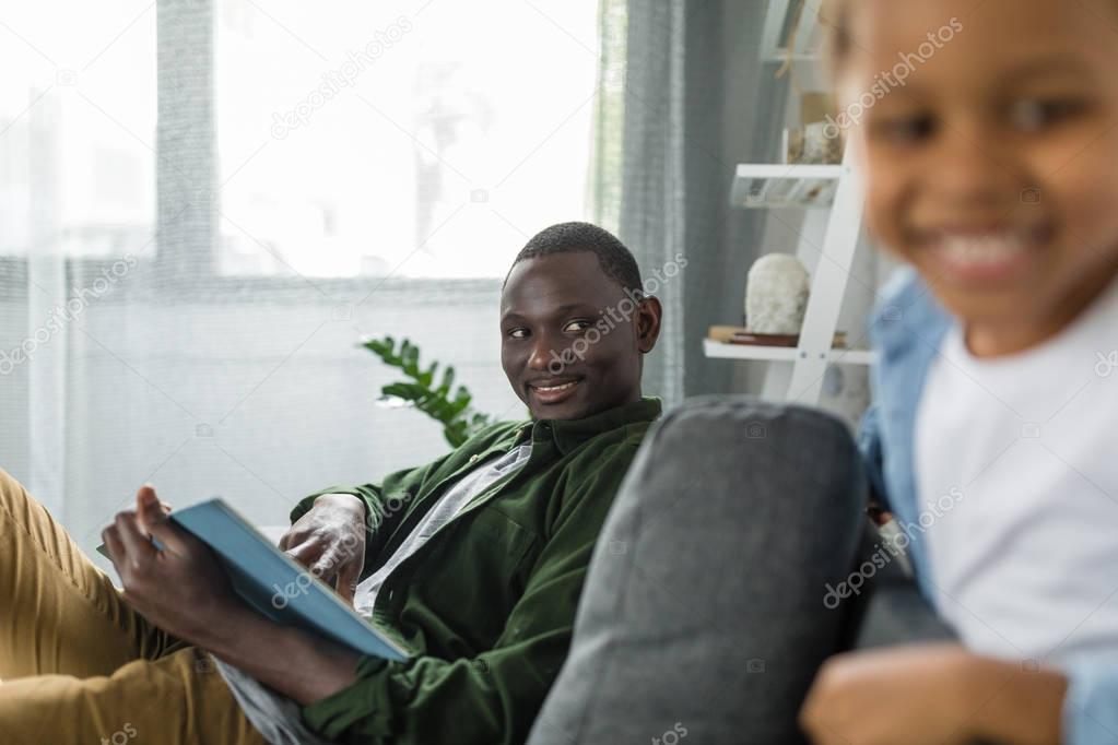 african-american son and father at home