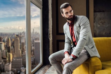 Şehir Manzaralı pencerede poz takım elbiseli şık adam