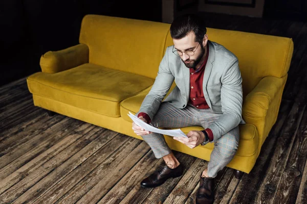 Stylish Man Trendy Grey Suit Reading Newspaper Sitting Couch — Stock Photo, Image