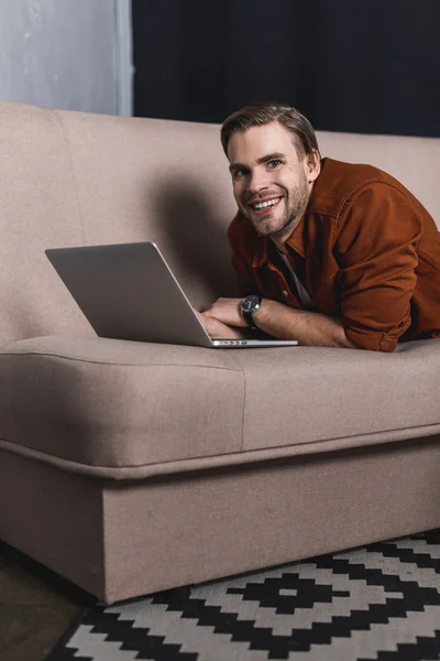 Young Happy Man Working Laptop Couch — Free Stock Photo