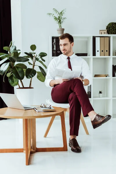 Homem Negócios Elegante Bonito Com Jornal Laptop Sentado Escritório Moderno — Fotografia de Stock