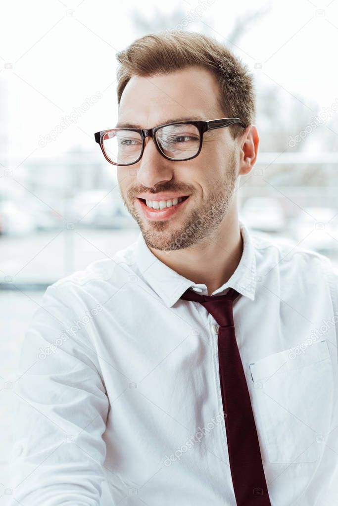 portrait of handsome caucasian businessman smiling in eyeglasses