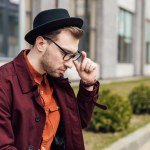 Handsome stylish man in glasses and trendy hat