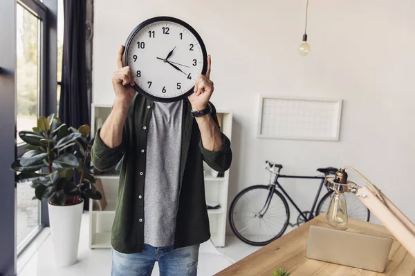 Hombre sosteniendo reloj - foto de stock