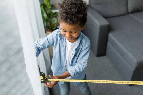 Adorable afro boy with measuring tape — Stock Photo