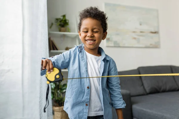 Adorable afro garçon avec ruban à mesurer — Photo de stock