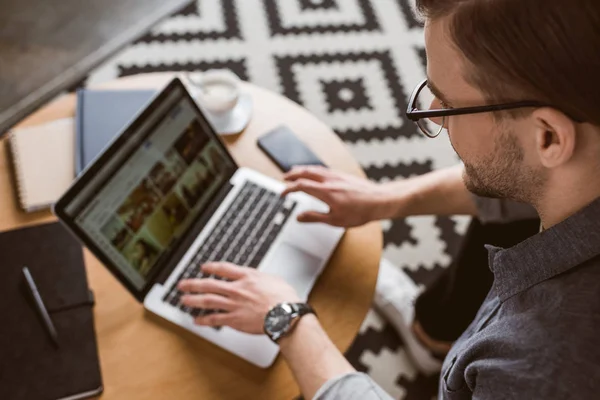 Close-up shot of young man working with laptop — Stock Photo