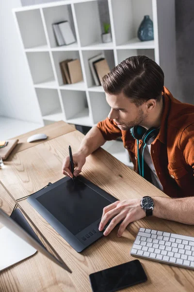 Young designer working with computer and drawing tablet — Stock Photo