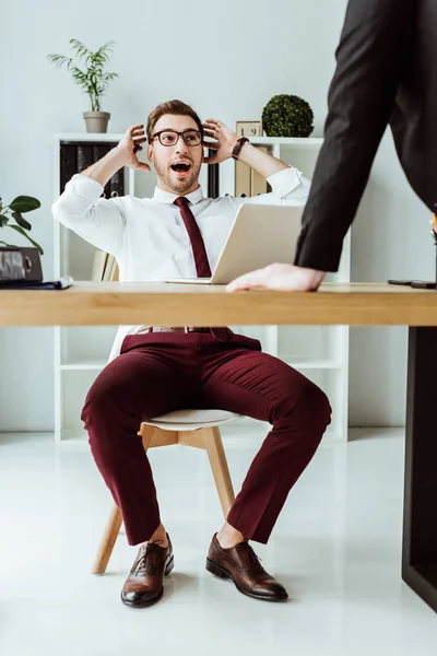 Homme d'affaires excité parler avec le patron sur le lieu de travail avec ordinateur portable — Photo de stock