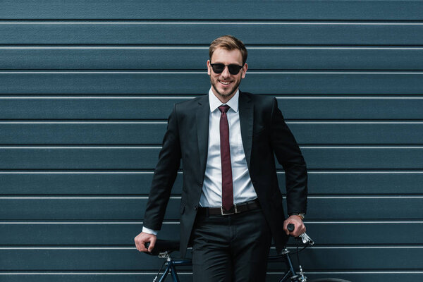 Stylish businessman with bicycle 