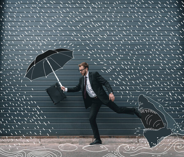 Businessman running with umbrella