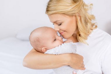 mother holding infant clipart
